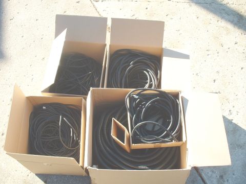 1986 Ford Bronco - Four cardboard boxes contain coiled black cables, likely for automotive use.