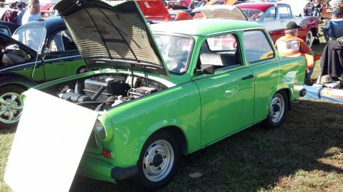 2007 Ford Mustang - A bright green Trabant 601 is displayed with its hood open at an outdoor event.