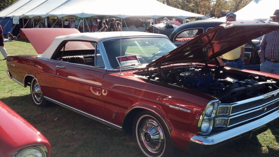 Red convertible with tan top, hood open showing engine. "FOR SALE" sign on windshield