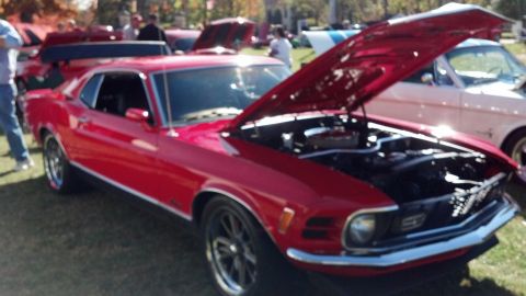 2007 Ford Mustang - Red classic coupe with hood open at a car show, another vehicle visible to the right.