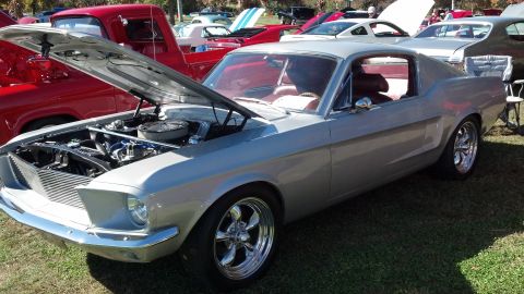 2007 Ford Mustang - A classic silver 1967 Ford Mustang coupe is displayed with its hood open at an outdoor car show.