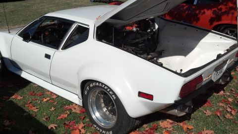 2007 Ford Mustang - White sports car with engine exposed, rear view, showing Dunlop tires.