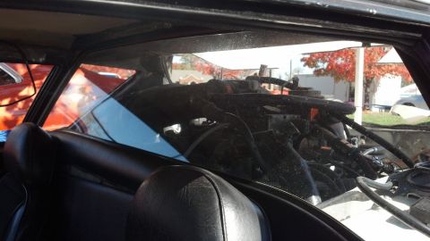 2007 Ford Mustang - Looking through the rear window at the engine and interior of a car.