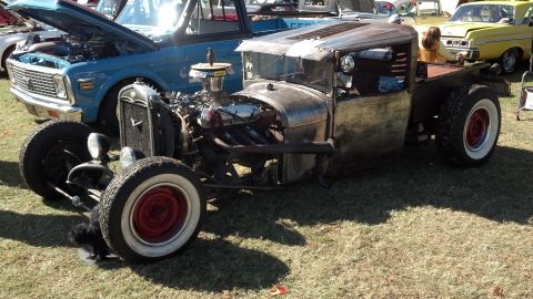2007 Ford Mustang - A heavily modified pickup truck with a visible engine and custom modifications sits on display.