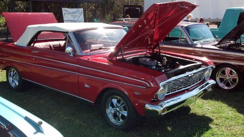 2007 Ford Mustang - A red 1964 Ford Falcon convertible is displayed with its hood open at an outdoor car show.