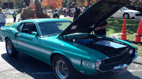 2007 Ford Mustang - A teal 1969 Ford Mustang GT350 is displayed with its hood open at an outdoor event.