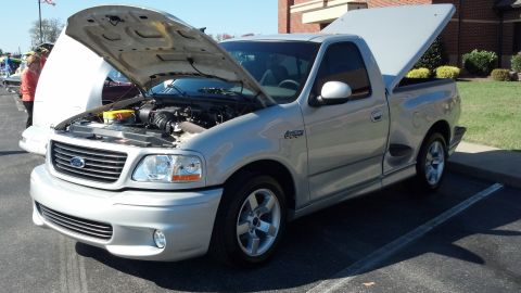 2007 Ford Mustang - Silver pickup truck with its hood and bed open, parked in a lot.