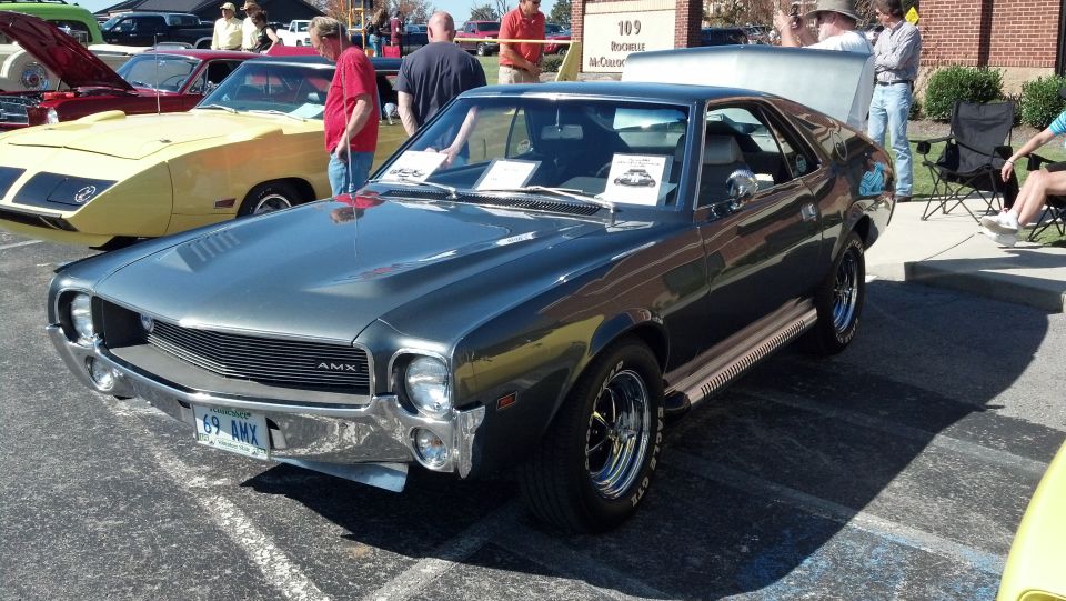 Gray 1969 AMC AMX with chrome bumper and side trim, parked on asphalt