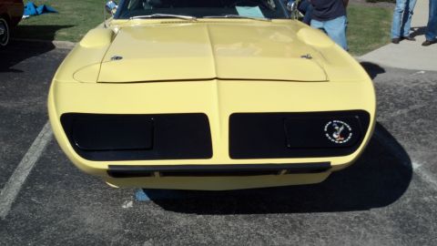 2007 Ford Mustang - A yellow 1970 Plymouth Barracuda is displayed with its distinctive front end, black grille inserts and hood scoops.