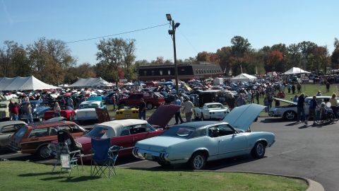 2007 Ford Mustang - A large gathering of classic cars at an outdoor event on a sunny day.