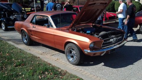 2007 Ford Mustang - A copper 1967 Ford Mustang coupe is displayed with its hood open at an outdoor car show.