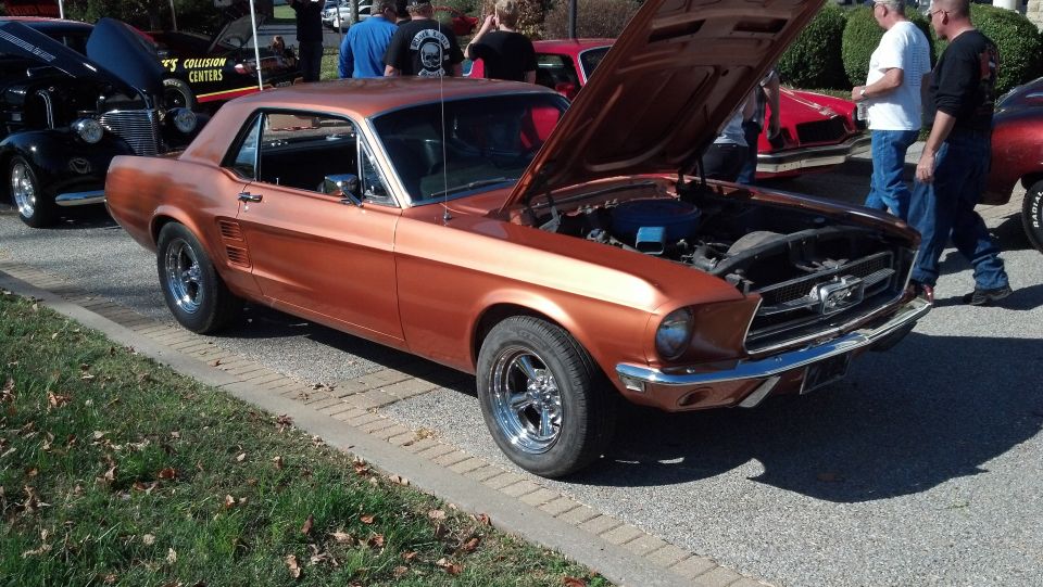 Copper 1967 Ford Mustang coupe with hood open, parked outdoors