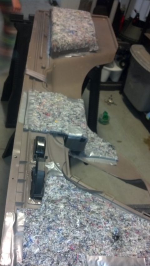 1995 Ford Bronco - Disassembled car interior panel with insulation material and visible components, likely undergoing repair or modification.