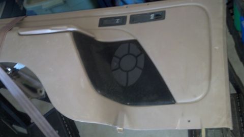 1995 Ford Bronco - Interior view of a car door panel a speaker grille and digital readouts.