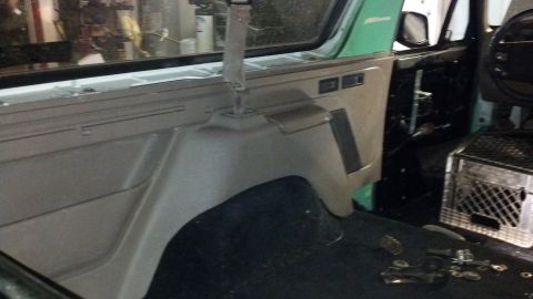 1995 Ford Bronco - The interior of a vehicle is shown, focusing on the center console and dashboard area around the passenger seat.