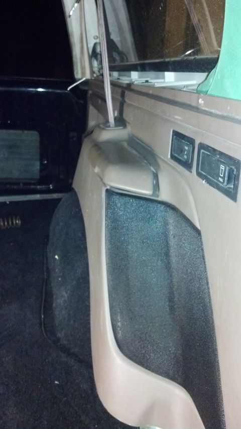 1995 Ford Bronco - Close-up view of the interior trim and rear wheel well of a vehicle, with a website watermark visible at the bottom.