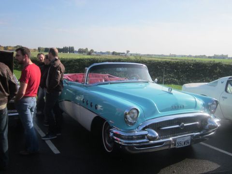 1991 Ford LTD Crown Victoria - A classic convertible is displayed outdoors with people gathered around it.