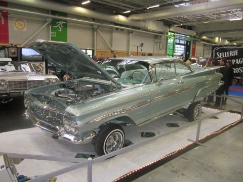 1991 Ford LTD Crown Victoria - Customized 1959 Chevrolet Impala on display at a car show, hood up revealing the engine.