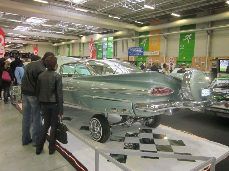 Lowrider 1959 Chevrolet Impala with continental kit, people looking
