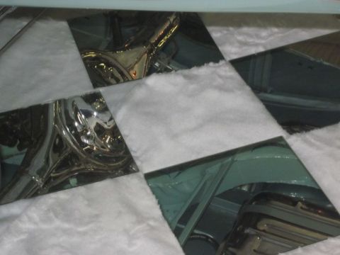 1991 Ford LTD Crown Victoria - Reflections of chrome and interior details are visible on glass panels covering a car's interior.