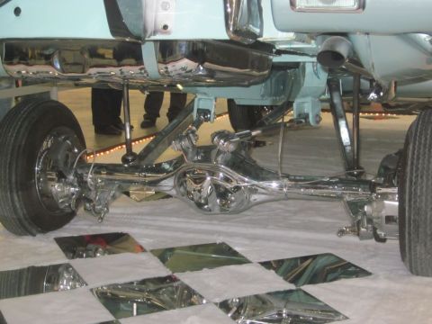 1991 Ford LTD Crown Victoria - Detailed view of the highly polished rear axle and suspension system of a custom car.