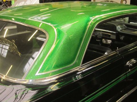 1991 Ford LTD Crown Victoria - Custom lowrider with a sparkling green roof and black body, interior visible.