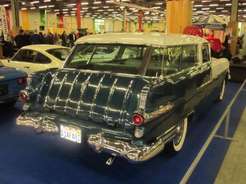 1991 Ford LTD Crown Victoria - This two-tone station wagon, likely a 1955 model, features extensive chrome detailing on its rear end.