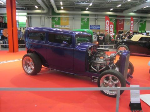 1991 Ford LTD Crown Victoria - A custom purple hot rod is displayed indoors, with another vehicle visible in the background.