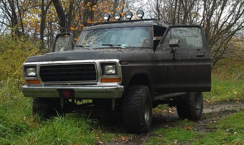 1979 Ford Bronco - This 1978 Ford Bronco is shown off-road with its doors open, covered in mud.