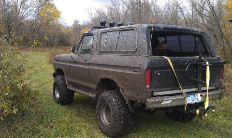 1979 Ford Bronco - This muddy 1979 Ford Bronco is ready for off-road adventure, auxiliary lights and a rear-mounted spare tire.