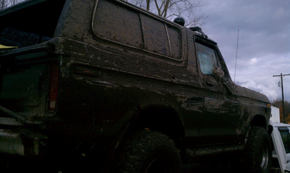 Mud-covered 1978 Ford Bronco parked outside