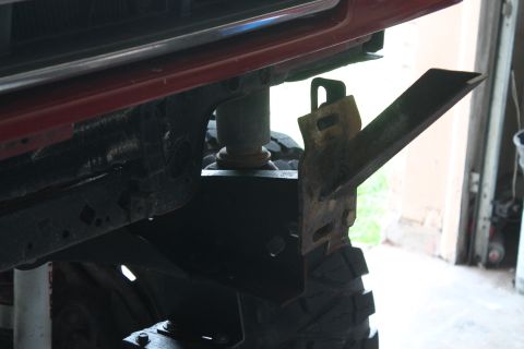 1990 Ford Bronco - Close-up of a custom bumper bracket installation on a vehicle's frame.