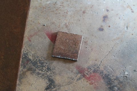 1990 Ford Bronco - A metal plate sits on a concrete surface, possibly a workshop floor.