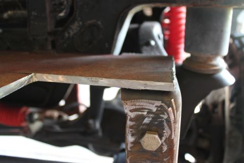 1990 Ford Bronco - Custom metalwork is being attached to the vehicle's frame for a bumper modification.