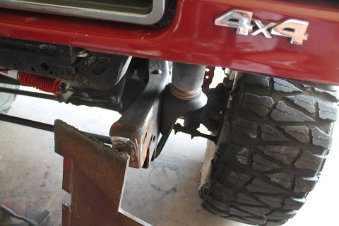 1990 Ford Bronco - Close-up of the 1990 Ford Bronco's 4x4 badge and suspension components.