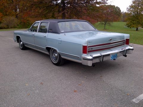 2001 Ford Crown Victoria - This classic Lincoln sedan, likely from the 1970s, features a distinctive two-tone paint scheme with a light blue body and black vinyl roof.