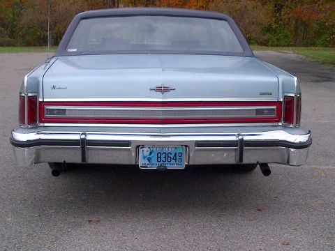 2001 Ford Crown Victoria - The rear of a sedan is visible, a chrome bumper and a license plate.