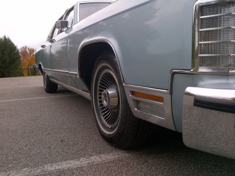 2001 Ford Crown Victoria - This light blue sedan features a classic body style with chrome accents and a wire wheel.