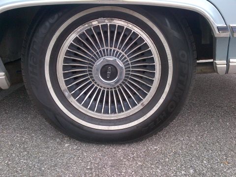 2001 Ford Crown Victoria - A close-up view of a Lincoln wheel and tire, showing the distinctive spoke design and whitewall detail.
