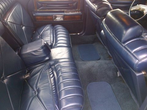 2001 Ford Crown Victoria - Interior view of a car with blue leather seats and matching carpet.