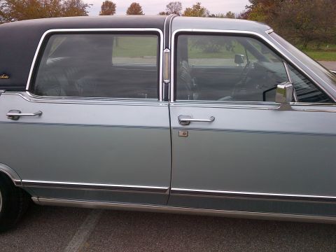 2001 Ford Crown Victoria - Side view of a vintage sedan with a two-tone roof and chrome accents.