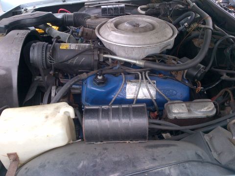 2001 Ford Crown Victoria - Close-up view of a vehicle's engine bay, showing various components and wiring.