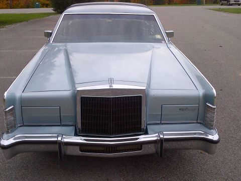 2001 Ford Crown Victoria - This Lincoln Continental has a distinctive grille and chrome accents, indicating an older model year.