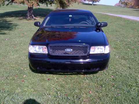 2001 Ford Crown Victoria - Front view of a black 2001 Ford Crown Victoria parked on a grassy lawn.