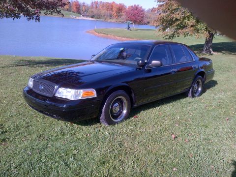 2001 Ford Crown Victoria - Black 2001 Ford Crown Victoria parked by a lake during the fall season.
