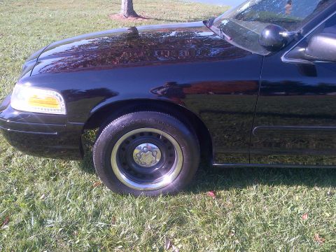 2001 Ford Crown Victoria - Front view of a 2001 Ford Crown Victoria showing the fender, headlight, and wheel.