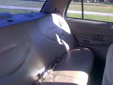 2001 Ford Crown Victoria - Interior view of a car's rear seat and door panel.