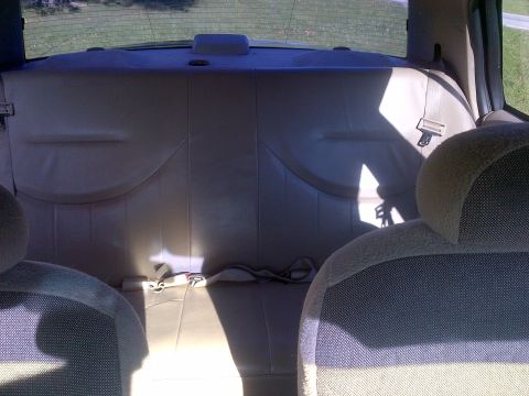 2001 Ford Crown Victoria - Rear interior view of a vehicle, showing the back seat and seatbelts.