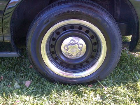 2001 Ford Crown Victoria - Wheel and tire detail shot with a chrome hubcap and trim ring.