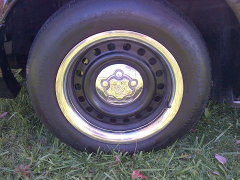 2001 Ford Crown Victoria - A close-up view of a vehicle's wheel and tire, showing the Ford emblem on the hubcap.